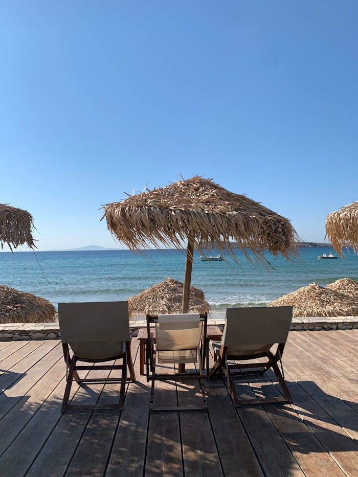 Two chairs and an umbrella on the beach